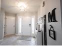 Bright foyer featuring tile flooring, decorative accents, and a welcoming entrance to the home at 9303 Aintree Dr, Indianapolis, IN 46250