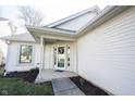 Inviting front entrance with decorative wreath and covered porch, enhancing curb appeal of the home at 9303 Aintree Dr, Indianapolis, IN 46250