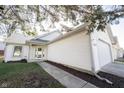 Well-maintained home with white siding, attached garage, and a tidy walkway leading to the front entrance at 9303 Aintree Dr, Indianapolis, IN 46250