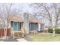 Charming home with gray siding, stone chimney, new front steps, and a pop of color on the front door at 953 S 5Th St, Noblesville, IN 46060