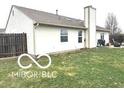 Backyard view featuring an outdoor green space and tall chimney at 1001 Maple W Dr, Lebanon, IN 46052