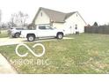 This single-story home features a neatly kept lawn and a long driveway at 1001 Maple W Dr, Lebanon, IN 46052