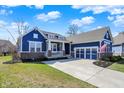 Blue single-Gathering home with attached three car garage, well-maintained lawn, and inviting curb appeal at 11072 Song Creek Ct, Fishers, IN 46040