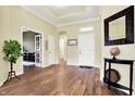 Inviting foyer with hardwood floors, neutral paint, and a view into the adjacent office at 11072 Song Creek Ct, Fishers, IN 46040