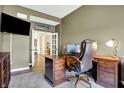 Cozy office with an executive desk, comfortable chair, and an adjacent sitting area at 11072 Song Creek Ct, Fishers, IN 46040