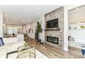 Stylish living room with modern fireplace, wood floors, and an open concept design at 11505 Langton Walk, Zionsville, IN 46077