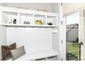 Bright mudroom with white cabinetry, storage cubbies, and convenient access to the outdoors at 11505 Langton Walk, Zionsville, IN 46077