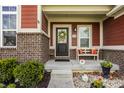 Inviting front porch with stylish seating and decorative accents, complemented by well-kept landscaping at 11925 Piney Glade Rd, Noblesville, IN 46060