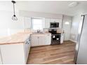 Modern kitchen featuring stainless steel appliances, butcher block countertops and white cabinets at 1246 Mcdougal St, Indianapolis, IN 46203