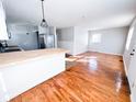 Bright living room featuring hardwood floors, fresh paint, and abundant natural light at 1246 Mcdougal St, Indianapolis, IN 46203