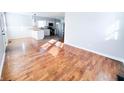 Open floor plan with hardwood floors connecting the living room to the modern kitchen at 1246 Mcdougal St, Indianapolis, IN 46203