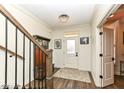Inviting foyer with hardwood floors, elegant lighting, and staircase at 12569 Branford St, Carmel, IN 46032