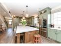 Well-equipped kitchen featuring a large island, stainless steel appliances, and custom cabinetry at 12569 Branford St, Carmel, IN 46032