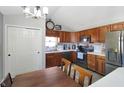 A traditional kitchen with wooden cabinets, black appliances, and a view of the breakfast area at 136 Meadow Glen Dr, Avon, IN 46123