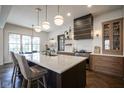 Stylish kitchen with a quartz-topped island, stainless steel appliances, and contemporary pendant lighting at 13947 Morningtide Cir, Fishers, IN 46038