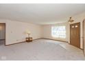 Inviting living room with carpet, a front door with sidelights, and neutral walls, offering a bright and airy feel at 1405 Creekside Dr, Brownsburg, IN 46112