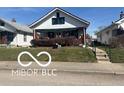 Inviting single-story home with a cozy covered porch and easy access via sidewalk and short steps at 1405 N Mount St, Indianapolis, IN 46222