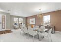Bright dining room featuring neutral walls, a modern chandelier, and seating for eight, perfect for entertaining at 15192 Porchester Dr, Noblesville, IN 46062