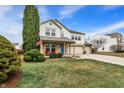 Beautifully landscaped front yard featuring a lush lawn, mature trees, and charming curb appeal for a welcoming feel at 15192 Porchester Dr, Noblesville, IN 46062