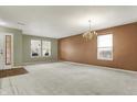 Spacious living room with plush carpeting, neutral walls, and natural light, creating an inviting and versatile space at 15192 Porchester Dr, Noblesville, IN 46062