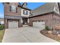Spacious driveway leading to a two-car garage, highlighting the home's brick and siding exterior at 1521 Avondale Dr, Westfield, IN 46074