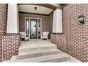 Inviting front porch with brick columns and seating area, creating a welcoming entrance at 1521 Avondale Dr, Westfield, IN 46074