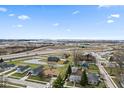 Aerial view displaying surrounding neighborhood, landscape and roads with highway visible in the distance at 1620 S East St, Lebanon, IN 46052