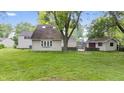 Expansive backyard featuring a lush lawn, mature trees, and a detached outbuilding at 1641 Whistler Terrace, Indianapolis, IN 46229
