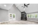 Bright living room with vaulted ceilings, a black stone fireplace and light wood floors at 1641 Whistler Terrace, Indianapolis, IN 46229