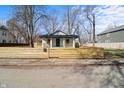View of the home surrounded by a new wooden fence at 1822 N Dexter St, Indianapolis, IN 46202