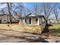 A charming home is showcased by a new wooden fence and landscaping at 1822 N Dexter St, Indianapolis, IN 46202