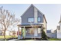 Stylish two-story home with modern design, including gray siding, large windows, and a welcoming front porch at 1955 Alvord St, Indianapolis, IN 46202
