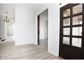 Bright, open-concept living room with modern flooring and views of a sliding barn door at 249 N Hamilton Ave, Indianapolis, IN 46201