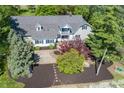 An aerial view of a home with beautiful landscaping, a large driveway, and a well-maintained lawn at 3548 W 500 North Rd, McCordsville, IN 46055