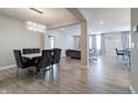 Open concept dining room showcasing modern chandelier and luxury dining set at 3581 Free Spirit Ct, Westfield, IN 46074
