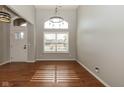 Inviting entryway with hardwood floors, high ceilings, and natural light streaming through a large window at 3792 Waterfront Way, Plainfield, IN 46168