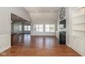 Spacious living room with hardwood floors, bright windows, and seamless transition to other rooms at 3792 Waterfront Way, Plainfield, IN 46168