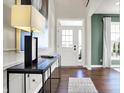 Welcoming foyer featuring hardwood floors and an elegant front door with glass panels at 4052 Saddle Club S Pkwy, Bargersville, IN 46106