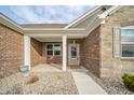 Inviting covered porch with stone accents and a decorative front door at 4720 W Tradwell Dr, New Palestine, IN 46163