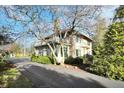 Beautiful exterior with a balcony view of the home with brick siding, a red tile roof and mature trees at 5224 Grandview Dr, Indianapolis, IN 46228