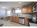 Functional kitchen featuring stainless steel appliances, light wood cabinets, and neutral countertops at 5415 Wallace Ave, Indianapolis, IN 46220