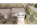 Aerial view of a well-maintained two-story home with an attached garage and view of the backyard at 5944 Edelle Dr, Indianapolis, IN 46237
