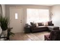 Cozy living room with a comfortable sectional sofa, bright window, and modern decor at 6724 E 52Nd St, Indianapolis, IN 46226