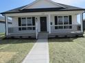 Charming single-story home featuring a covered front porch and freshly landscaped yard at 769 E Pearl St, Whiteland, IN 46184