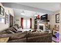 Cozy living room with a stone fireplace, a comfortable sectional, and French doors leading outside at 7965 Benjamin Dr, Lawrence, IN 46226