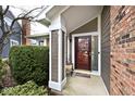 Welcoming covered porch with decorative column, sidelight, and space for decor at 8077 Foxchase Dr, Indianapolis, IN 46256