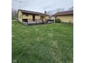 Exterior view of house with a well-kept lawn and dark wood deck at 839 S Paddock Rd, Greenwood, IN 46143