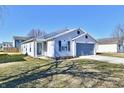 Charming single-story home with a well-maintained lawn and a two-car garage at 888 Streamside Dr, Greenfield, IN 46140