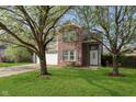 Charming two-story home featuring a well-maintained lawn and mature trees, creating a serene setting at 9011 Harrison Run Dr, Indianapolis, IN 46256