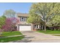 Beautiful home with a spacious driveway, attached garage, and vibrant landscaping for curb appeal at 9011 Harrison Run Dr, Indianapolis, IN 46256